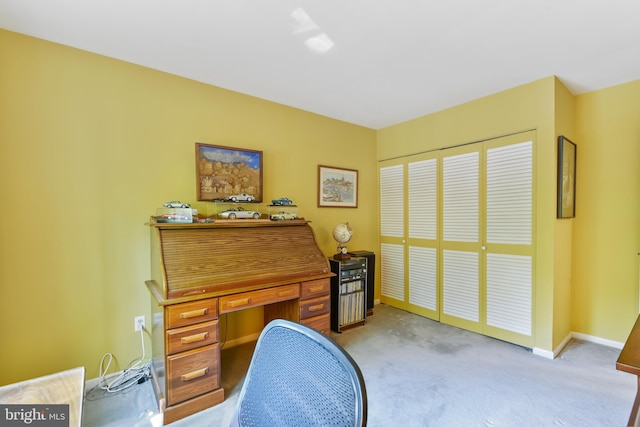 home office featuring baseboards and light carpet