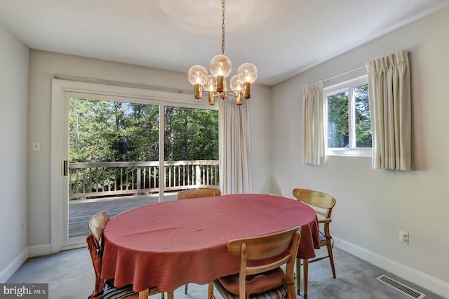 dining space with an inviting chandelier, baseboards, carpet flooring, and visible vents