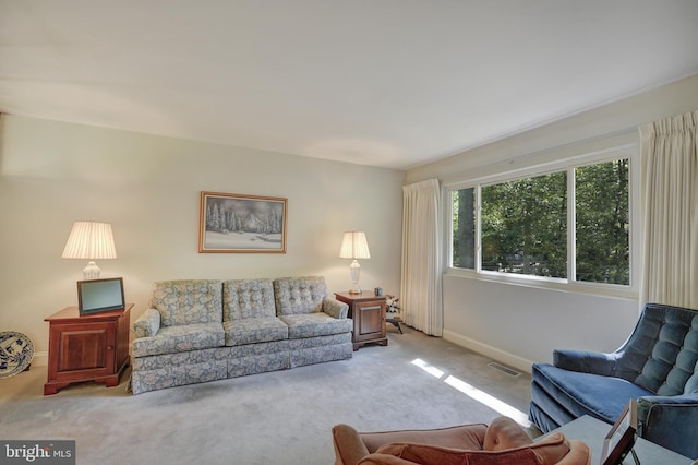 living area featuring carpet floors, baseboards, and visible vents