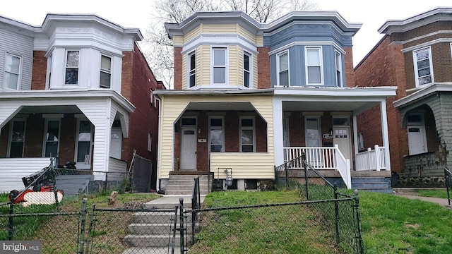 2215 Mount Holly St, Baltimore, MD 21216 - view of front of home featuring a porch, a gate, and a fenced front yard