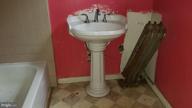 2215 Mount Holly St, Baltimore, MD 21216 - bathroom with tile patterned floors and a bathing tub