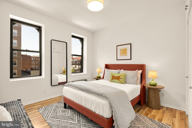 bedroom with baseboards and light wood-type flooring