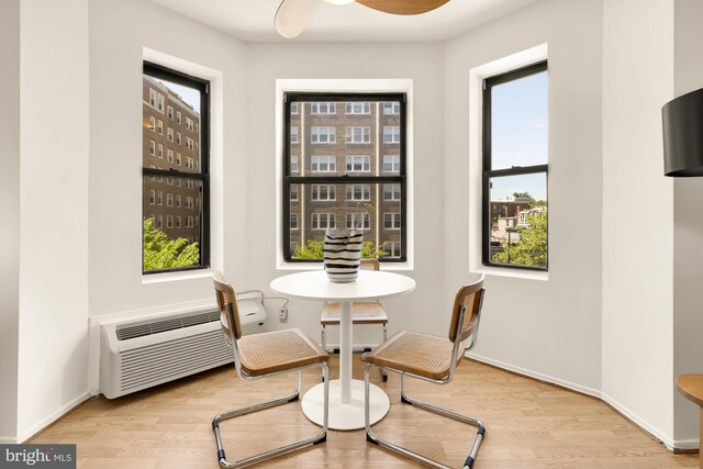 dining area with plenty of natural light, wood finished floors, a ceiling fan, and baseboards