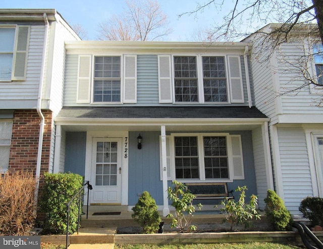 townhome / multi-family property with a porch