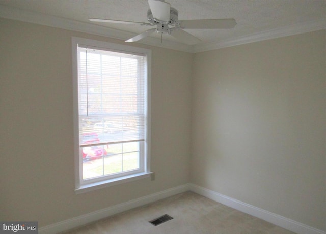 spare room featuring ceiling fan, baseboards, visible vents, and plenty of natural light