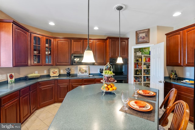 158 Mccormick Dr, Port Deposit, MD 21904 - kitchen featuring black appliances, dark countertops, decorative light fixtures, glass insert cabinets, and reddish brown cabinets
