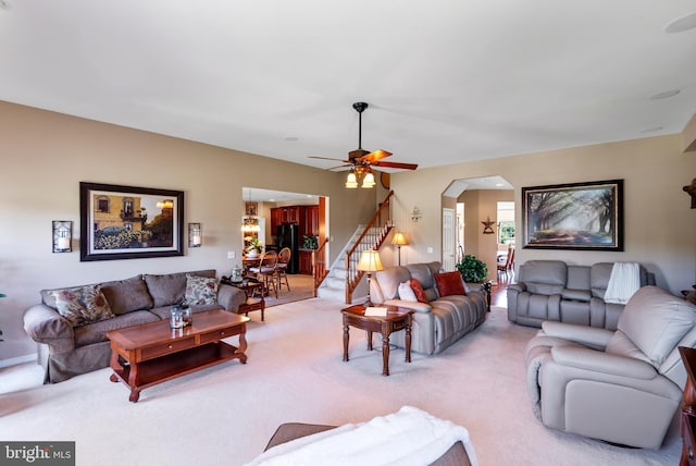 158 Mccormick Dr, Port Deposit, MD 21904 - living room featuring light carpet, stairs, ceiling fan, and arched walkways