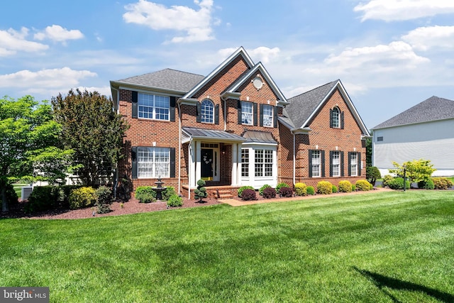 158 Mccormick Dr, Port Deposit, MD 21904 - view of front of home with brick siding, a front lawn, and a standing seam roof