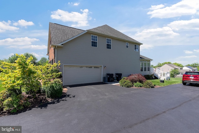 158 Mccormick Dr, Port Deposit, MD 21904 - view of property exterior featuring driveway, roof with shingles, and a garage