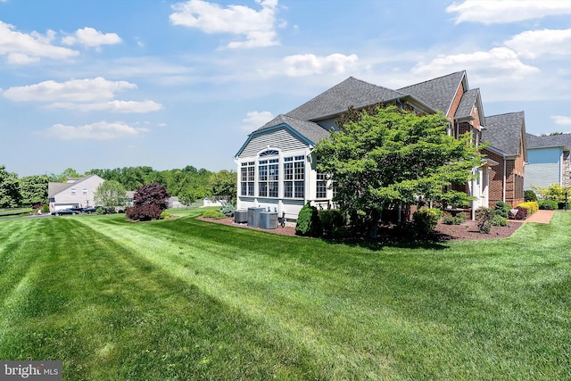 158 Mccormick Dr, Port Deposit, MD 21904 - rear view of house with central AC unit, a lawn, a shingled roof, and brick siding