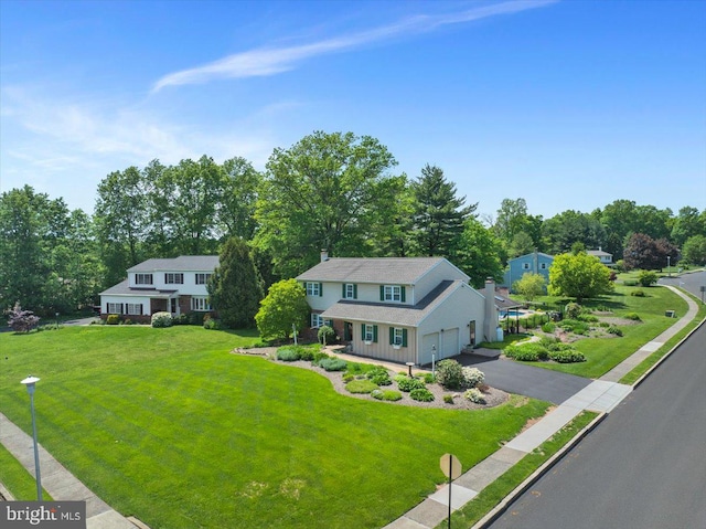 aerial view of property and surrounding area with a tree filled landscape