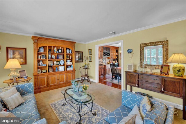 living room featuring ornamental molding, carpet flooring, and baseboards