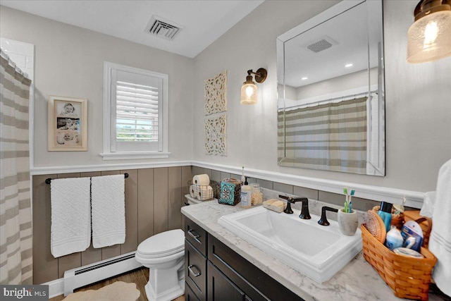 full bathroom with a baseboard heating unit, a wainscoted wall, toilet, vanity, and a shower with shower curtain