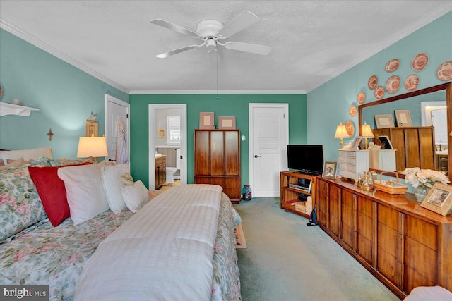 carpeted bedroom featuring ornamental molding, a textured ceiling, ensuite bath, and a ceiling fan