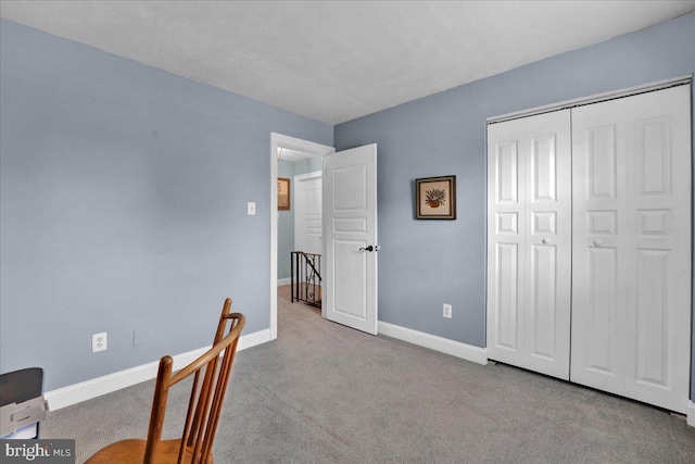 carpeted home office with baseboards