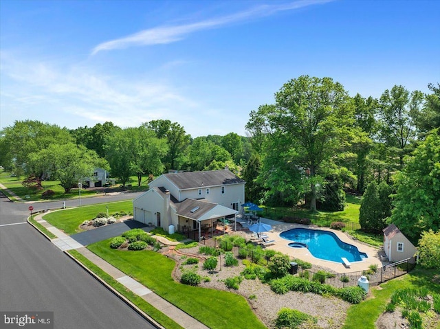 aerial view of property and surrounding area with a pool area