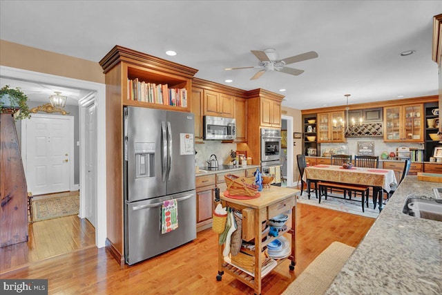 kitchen featuring stainless steel appliances, a chandelier, tasteful backsplash, and recessed lighting