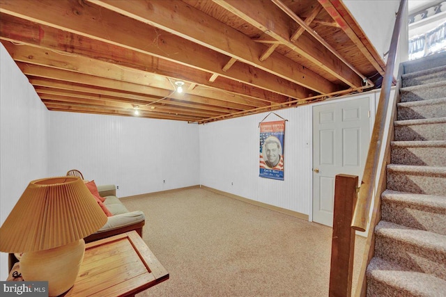below grade area with stairway, carpet floors, and baseboards