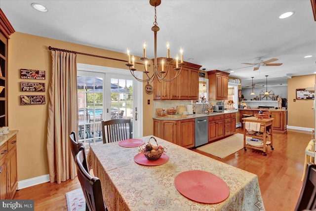 dining space featuring a chandelier, light wood-style flooring, a ceiling fan, baseboards, and recessed lighting