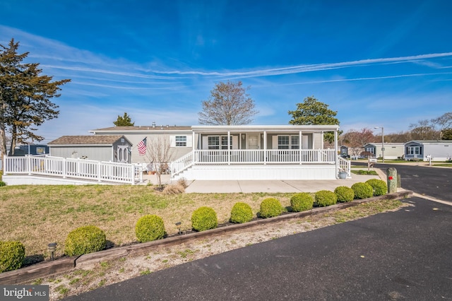 398 Grande Blvd, Rio Grande, NJ 08242 - manufactured / mobile home with a porch and a front lawn