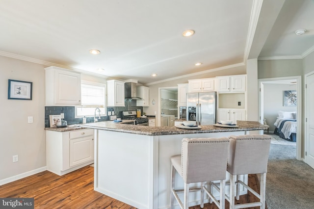398 Grande Blvd, Rio Grande, NJ 08242 - kitchen with wall chimney range hood, a breakfast bar, crown molding, stainless steel appliances, and a kitchen island