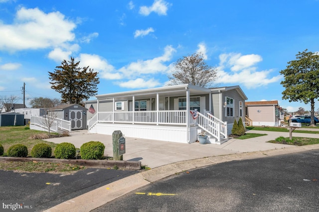 398 Grande Blvd, Rio Grande, NJ 08242 - manufactured / mobile home with an outbuilding, covered porch, and a storage unit