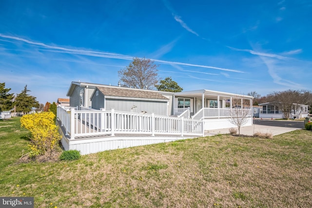 398 Grande Blvd, Rio Grande, NJ 08242 - view of front of house featuring a porch, a shingled roof, and a front lawn