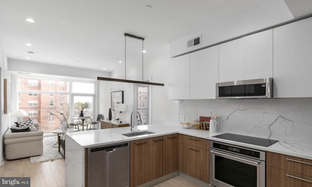 7700 Georgia Ave NW Unit 303, Washington, DC 20012 - kitchen with stainless steel appliances, visible vents, modern cabinets, and a sink