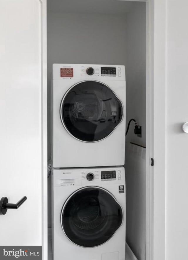 7700 Georgia Ave NW Unit 303, Washington, DC 20012 - clothes washing area with stacked washer and dryer and laundry area
