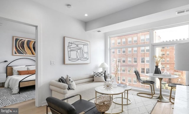 7700 Georgia Ave NW Unit 303, Washington, DC 20012 - living room with a wealth of natural light, visible vents, and wood finished floors