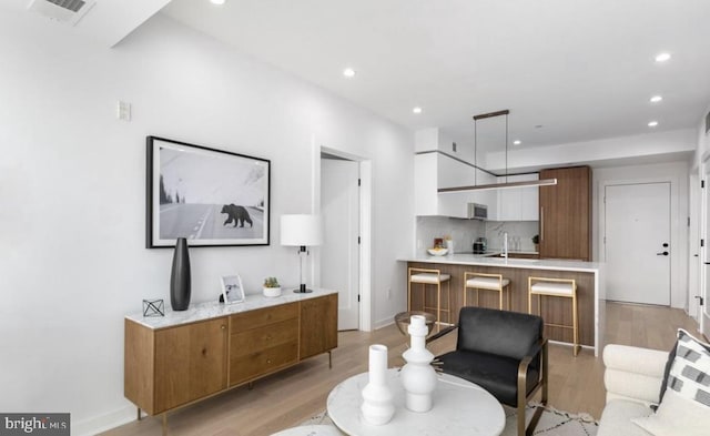 7700 Georgia Ave NW Unit 303, Washington, DC 20012 - dining room featuring visible vents, light wood-style flooring, and recessed lighting