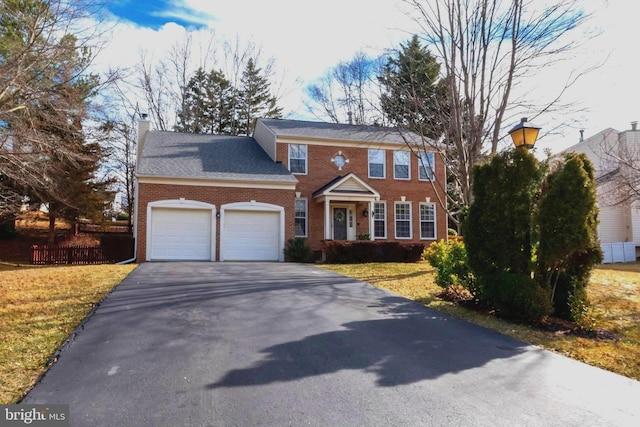 37 Blossom Wood Ct, Stafford, VA 22554 - colonial-style house with a garage, a chimney, fence, brick siding, and driveway