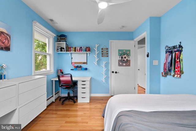 bedroom featuring light wood-style floors, a ceiling fan, visible vents, baseboards, and baseboard heating