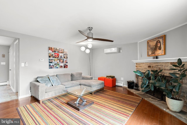 living room with a baseboard radiator, wood finished floors, a ceiling fan, and an AC wall unit