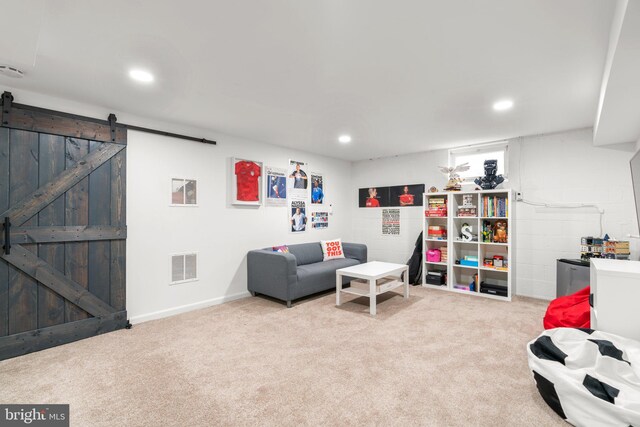 living area with carpet, visible vents, recessed lighting, and a barn door