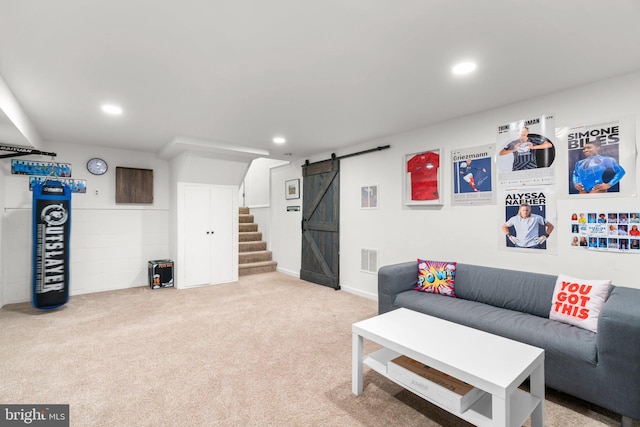 carpeted living room with visible vents, a barn door, stairs, and recessed lighting