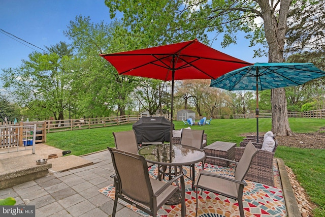 view of patio with an outdoor structure, area for grilling, a shed, outdoor dining space, and a fenced backyard