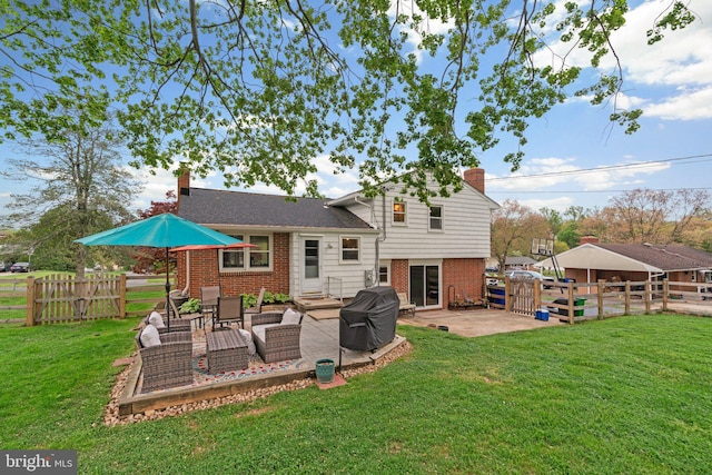 back of house with a chimney, brick siding, a gate, and a patio area