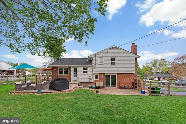 back of house with a patio, fence, and a lawn