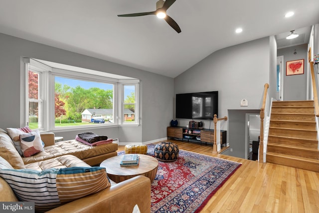living room featuring recessed lighting, lofted ceiling, a ceiling fan, stairs, and wood finished floors