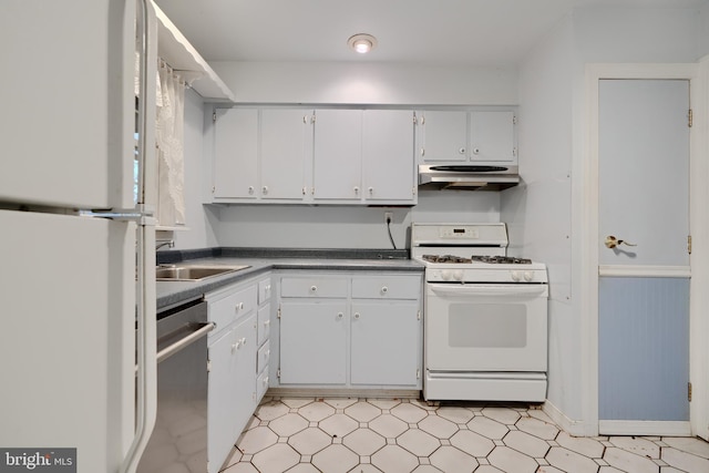 kitchen with dark countertops, a sink, white appliances, light floors, and range hood