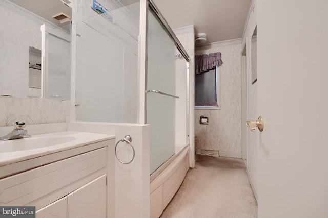 full bath with wallpapered walls, combined bath / shower with glass door, and vanity