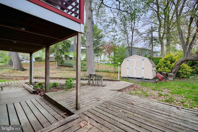 wooden deck featuring a storage unit and an outbuilding