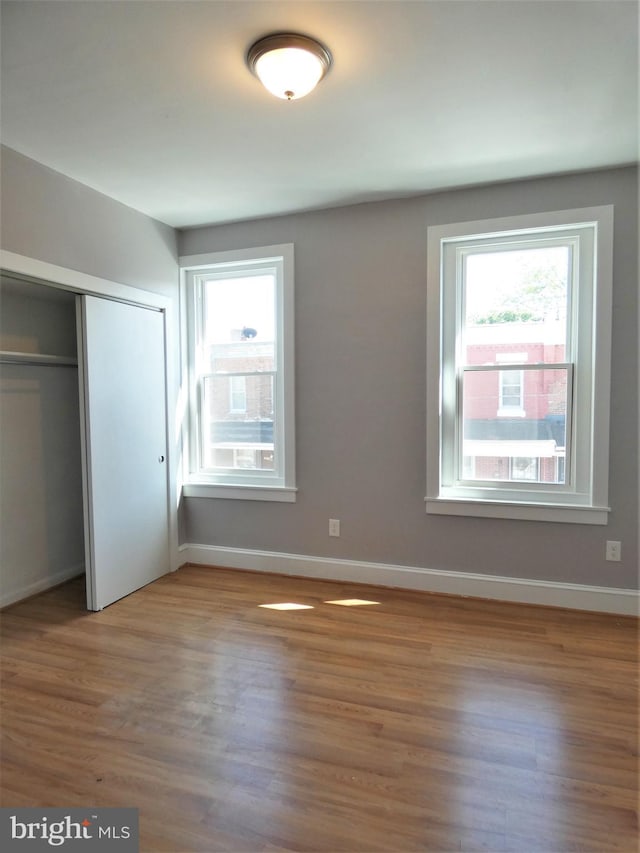 2147 W Grange Ave, Philadelphia, PA 19138 - unfurnished bedroom with a closet, baseboards, and wood finished floors
