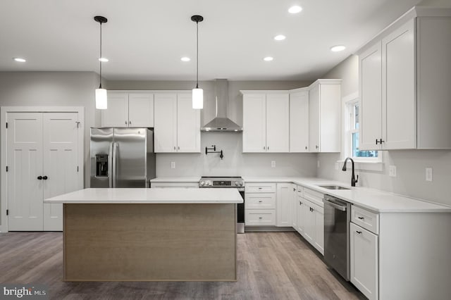 309 Gun Club Rd, Stephenson, VA 22656 - kitchen with appliances with stainless steel finishes, a sink, wall chimney range hood, and wood finished floors