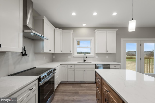 309 Gun Club Rd, Stephenson, VA 22656 - kitchen with range with electric cooktop, a sink, wall chimney range hood, white cabinetry, and stainless steel dishwasher