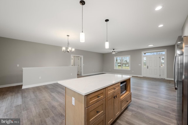 309 Gun Club Rd, Stephenson, VA 22656 - kitchen with appliances with stainless steel finishes, wood finished floors, light countertops, open floor plan, and baseboards