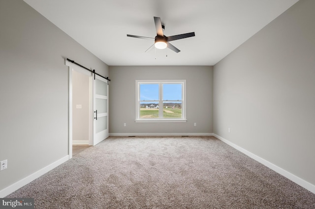 309 Gun Club Rd, Stephenson, VA 22656 - unfurnished bedroom featuring a barn door, baseboards, light colored carpet, and ceiling fan
