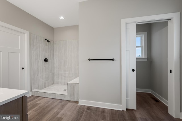 309 Gun Club Rd, Stephenson, VA 22656 - bathroom featuring baseboards, tiled shower, and wood finished floors