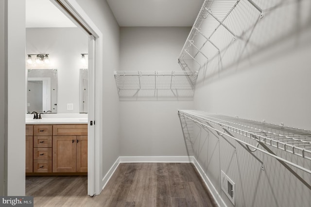 309 Gun Club Rd, Stephenson, VA 22656 - spacious closet with dark wood-type flooring, visible vents, and a sink